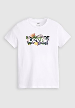 Vit bomull t-shirt med en färgglad blommig grafik och texten "Levi's" centrerad i en böjd design. Korta ärmar och rundad halsringning.