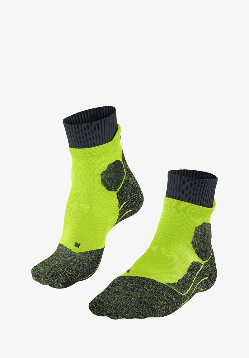 Groene en zwarte sportkousen met een geribbelde zwarte boord, patroonstructuur en versterkte tenen en hakken voor ondersteuning.