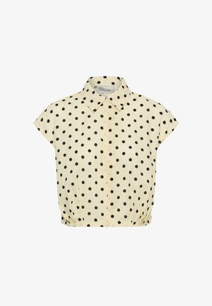 Bézs rövid ujjú blúz fekete pöttyökkel, hegyes nyakkal, elöl cipzárral és rugalmas szegéllyel.