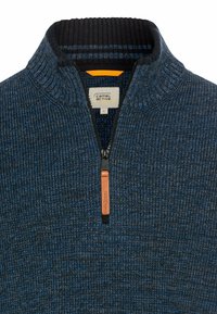 Blue textured sweater with a quarter zip, ribbed navy collar, and brown leather zipper pull. Label visible inside. Size: L.