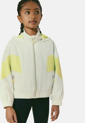 Ľahká, biela windbreaker bunda so žltými akcentmi, s plným zipsom a kapucňou. Obsahuje elastické manžety a bočné vrecká. Hladký povrch.