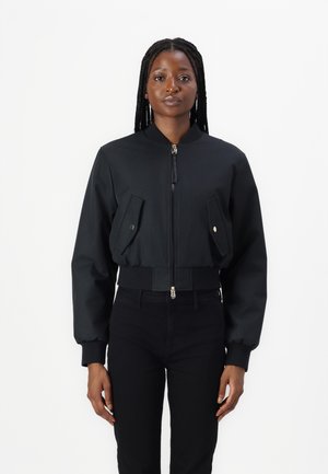 Cropped black bomber jacket with a zip front, two front pockets, and ribbed cuffs. Made from a smooth fabric with a matte finish.