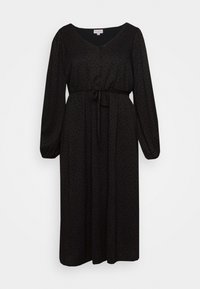 Svart klänning med långa ärmar, V-ringning, framknappar och ett band i midjan. Har ett subtilt prickmönster genom hela plagget.