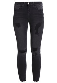 Black skinny jeans made from denim, featuring distressed rips at the knees, traditional five-pocket design, and a button closure at the waist.