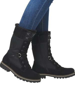 Bottes étanches noires en cuir et daim. Design à lacets avec une fermeture éclair latérale et une doublure en fourrure en haut. Semelle durable.