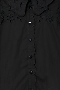 Black blouse featuring a scalloped collar and floral embroidery. It has glossy black buttons and a smooth fabric texture.