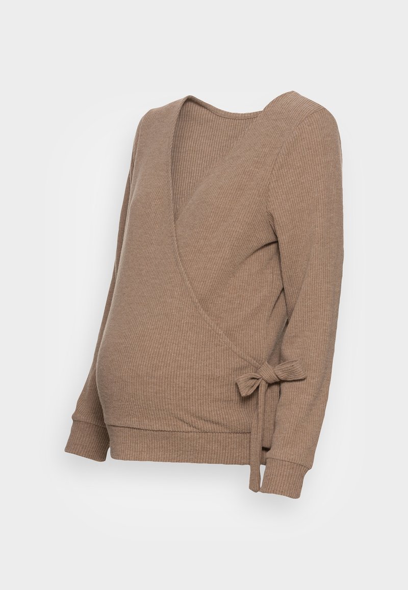 Haut de grossesse à manches longues en tricot côtelé marron clair, avec fermeture à nouer sur le côté et encolure en V, sur fond blanc.
