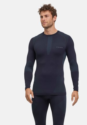 Marineblaues Langarm-Aktivshirt mit strukturierten Einsätzen und taillierter Passform. Mit rundem Halsausschnitt und dezentem Branding auf der Brust.