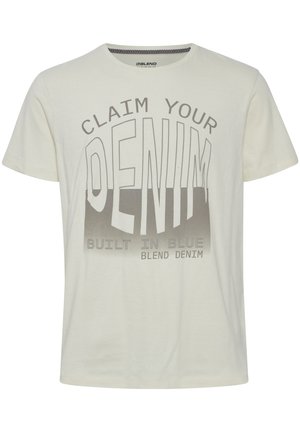 Krem T-skjorte laget av bomull, med et grafisk trykk i grått som sier "CLAIM YOUR DENIM" med "BUILT IN BLUE" under.