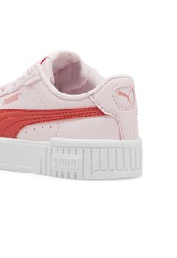 Adidași Puma în nuanțe de roz pal și corali, prezentând un superior sintetic texturat, vârf rotund și o talpă groasă din cauciuc alb cu accente nervurate.