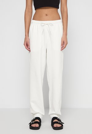 Witte, losse sweatpants met een elastische tailleband en trekkoord. Zacht stof met een gladde textuur en zijzakken.