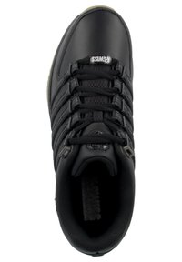 Black athletic shoe with a smooth upper, textured accents, flat laces, and a rubber sole. Features a honeycomb design near the laces.