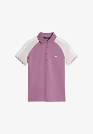 Lyhythihainen polo-paita vaaleanliilassa, jossa on kaulus, erottuvat valkoiset raglan-hihat, kolmen napin napitus ja logoyksityiskohta.