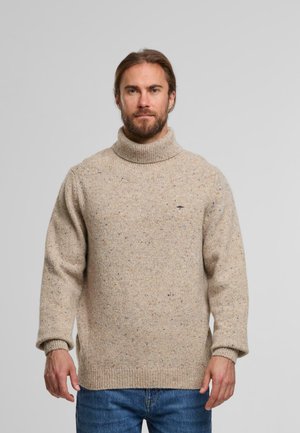 Beige knit turtleneck sweater with a textured finish, featuring speckled multicolored fibers. Ribbed cuffs and hem, relaxed fit.