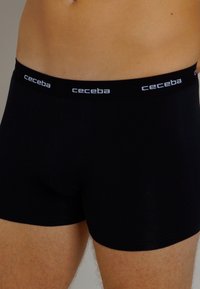 Schwarze Baumwoll-Boxershorts mit einem weichen elastischen Bund, der das "ceceba"-Logo in Weiß zeigt. Der enganliegende Schnitt betont Komfort und Unterstützung.