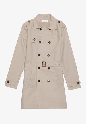 Beige trench coat with double-breasted design, large dark buttons, belted waist, shoulder epaulets, and two frontal pockets.