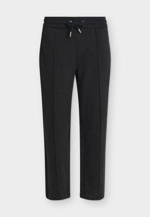 Pantalon noir fuselé avec une taille élastique et un cordon, présentant une subtile texture côtelée verticale.