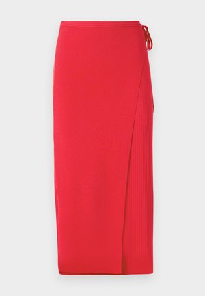 Red ribbed knit midi skirt with a side slit, featuring a tie detail at the waist. Smooth texture with a fitted silhouette.
