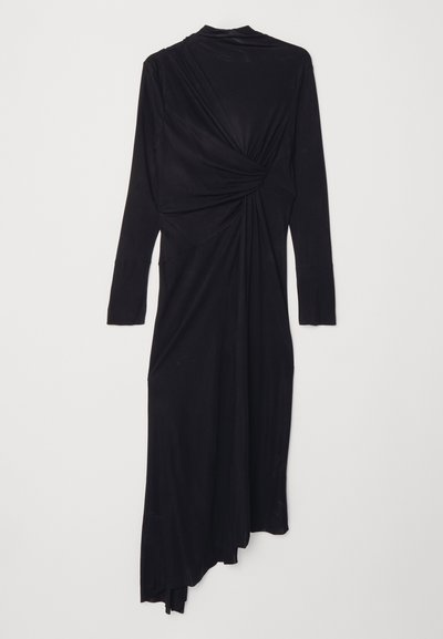 Black long-sleeve dress with a draped design, featuring a twist detail at the waist and a flowing asymmetrical hem. Soft fabric texture.