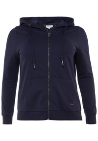 Navy mikina na zip z měkké tkaniny, se skrytou kapsou, kapucí se stahovacími šňůrkami a žebrovanými manžetami. Diskrétní loga značky na lemu.