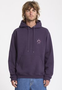 Purple cotton hoodie with a front pocket, adjustable drawstrings, and a small pink star logo on the left chest. Relaxed fit, ribbed cuffs.