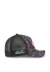 Casquette noire avec un motif de taches colorées, dos en maille et visière courbée. Comprend une patch "CRUCIAL CATCH INTERCEPT CANCER" sur le côté.