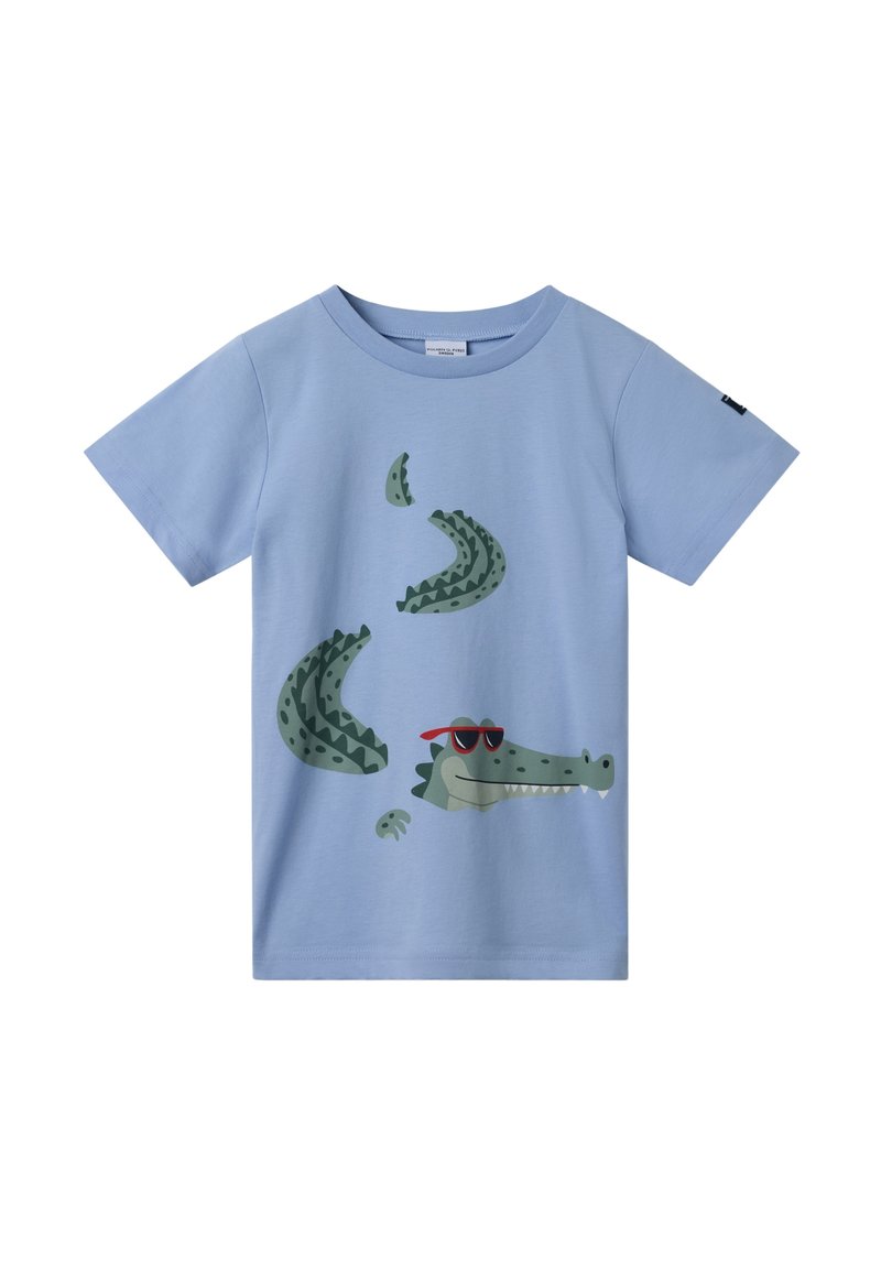 Vaaleansininen puuvillateepaita, jossa on vihreä krokotiilikuva punaisissa aurinkolaseissa, kuvioiduilla suomilla ja pyöreällä kaula-aukoilla.