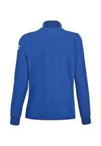 Blå langærmet jakke med høj krave set bagfra, med et lille hvidt logo på den øverste højre ærme.