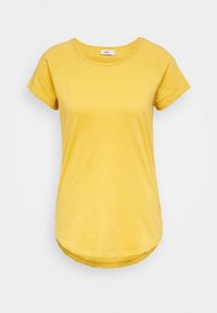 Żółta koszulka z okrągłym dekoltem i krótkimi rękawami raglanowymi. Posiada lekko zakrzywiony dół oraz miękką, teksturowaną tkaninę.