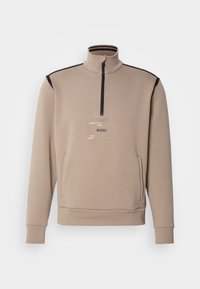 Beige mikina na čtvrt zip s černými lemy na ramenou, předními kapsami, žebrovanými manžetami a potiskem loga "BOSS" a pruhy na hrudi.
