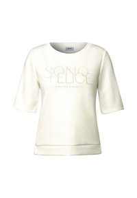 Felpa color crema con maniche corte, caratterizzata da testo impresso "SONO FELICE" e "DISCOVER & ENJOY" sul davanti, con una texture morbida.