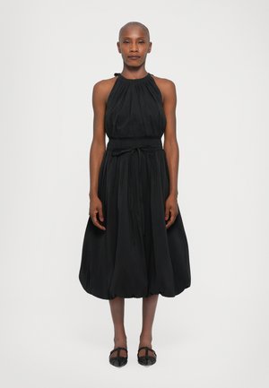 Black halter-neck dress with gathered fabric, fitted waist, and a flared, knee-length skirt. Features a tie at the waist and smooth texture.