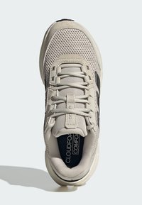 Light gray sneaker featuring a mesh upper, textured accents, black logo detail on the side, and a cushioned sole.