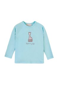 Camicia a maniche lunghe azzurro chiaro realizzata in tessuto morbido, con un design di giraffa ricamato in marrone e del testo sottostante. Collo rotondo e maniche raglan.