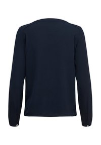 Chemise bleu marine à manches longues avec poignets boutonnés vue de dos, présentant une texture de tissu simple et lisse.