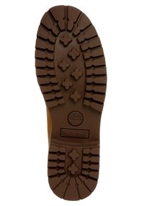 Suela de bota de goma marrón con un dibujo de patrón que presenta zonas elevadas y un logo de árbol. Diseño robusto para una mejor tracción y durabilidad.