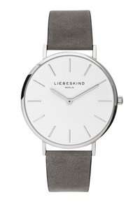 Rund silverfärgad klocka med en vit urtavla, minimalistiska markörer och ett grått läderarmband. Har en slät yta och subtil branding.