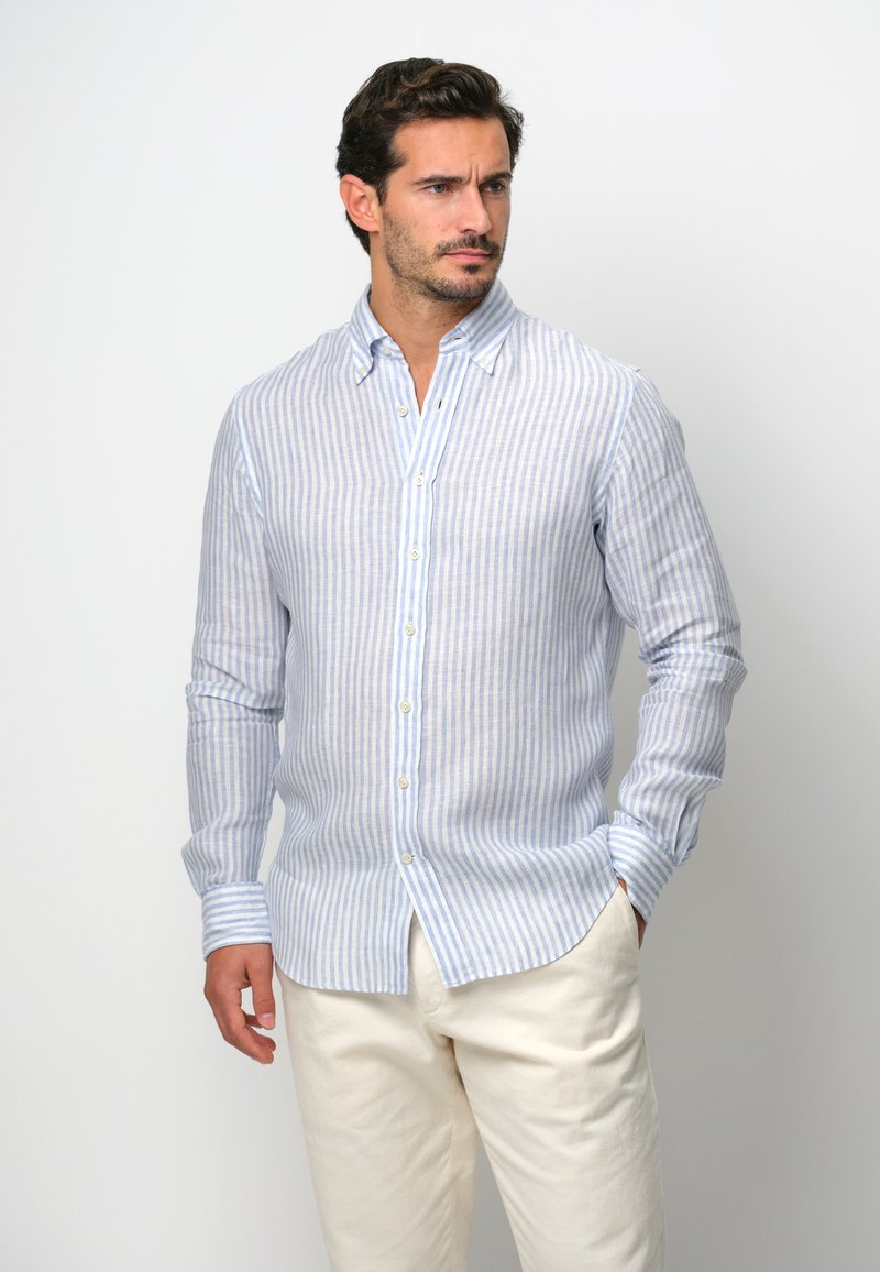 Pasiasta koszula z długim rękawem w jasnoniebieskim i białym kolorze, wykonana z lekkiego materiału, z miękkim kołnierzykiem i mankietami typu barrel.