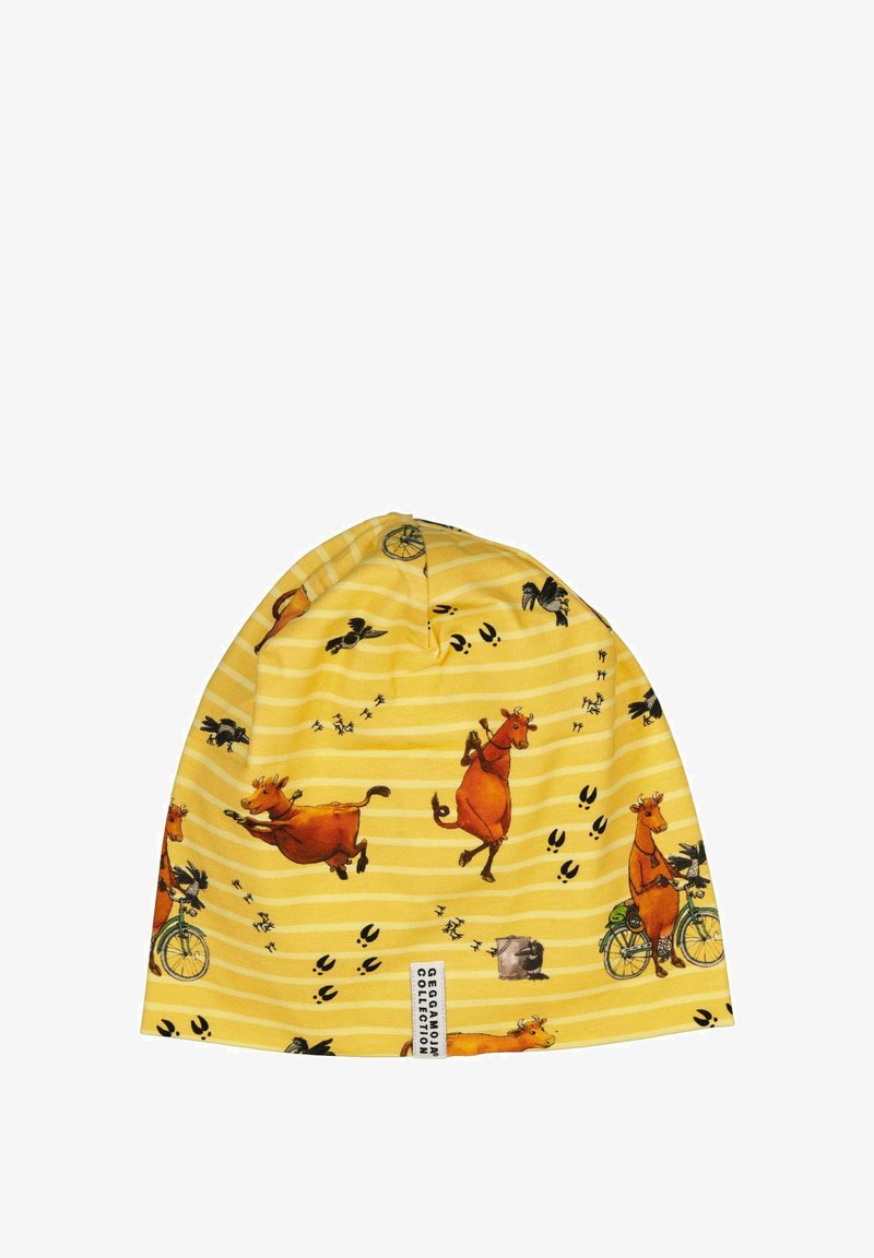 Keltainen pipo, jossa on leikillinen lehmäkuviointi, sisältäen raidallisen kuvion, sarjakuvamaisia lehmiä ja lintuja. Valmistettu pehmeästä kankaasta, jossa on ommeltu etiketti.