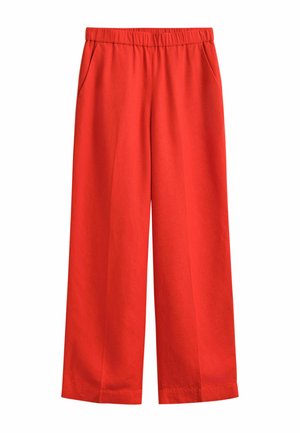 Rode wijde broek met elastische tailleband en zijzakken, gemaakt van zachte stof.