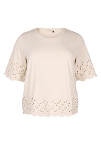Top corto a maniche corte color beige chiaro realizzato in tessuto morbido. Presenta un orlo scallop con dettagli a taglio, che migliorano la texture e il design.