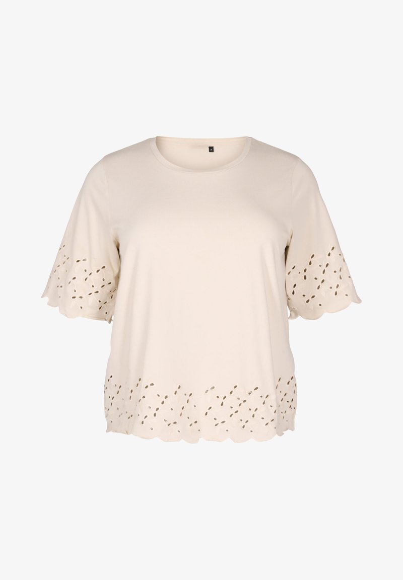 Šviesiai smėlinė trumpa rankovė viršutinė dalis, pagaminta iš švelnios medžiagos. Išsiskiria banguotu apatine dalimi su išpjovomis, pabrėžiančiomis tekstūrą ir dizainą.