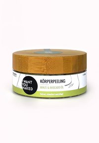 Lichaamspeeling in een ronde container met een bamboeklep. Het etiket heeft groene en witte kleuren met een zwart cirkel logo. Geuren: munt en avocado-olie.