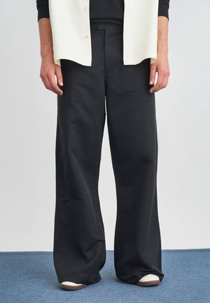 LOOSE FLARED  - Trousers - black
