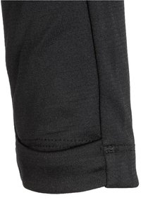 Schwarze Strumpfhose aus gestricktem Stoff mit flachgenähtem Saum. Die Textur ist glatt mit einem leichten Stretch und einem formschmeichelnden Design.