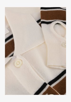 Stickad pikétröja i krämfärg med bruna och svarta ränder. Har krage, korta ärmar och knappstängning. Mjukt, texturerat tyg.