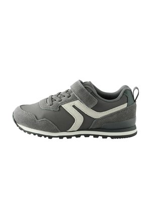 Gray athletic shoe with a suede and mesh upper, featuring a white accent design, lace closure, and a Velcro strap. Textured rubber sole.