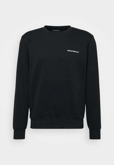 Sweatshirt noir en mélange de coton avec un col rond. Présente des bords-côtes aux poignets et à l'ourlet, un petit logo blanc sur la poitrine et une texture douce.