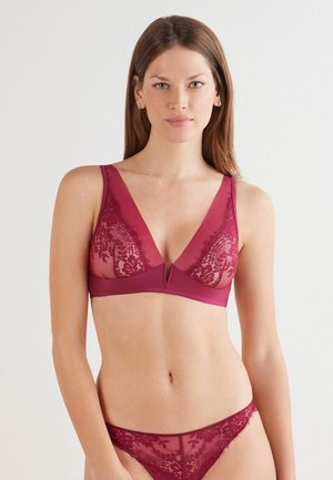 Lace bralette and matching thong in deep burgundy, featuring a v-neckline, floral lace overlay, and wide shoulder straps.