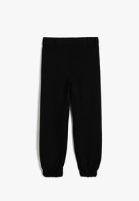 Svarta joggers i mjukt tyg, med elastisk midja och smalnande muddar. Slät yta, utan mönster eller dekorationer.
